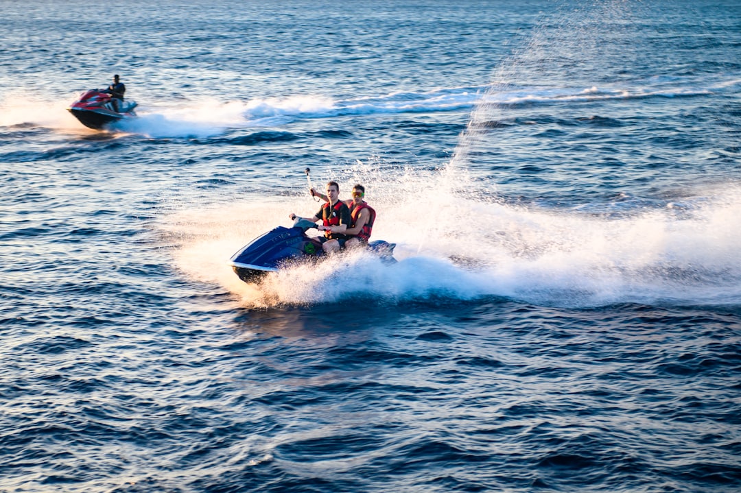 Two people riding a jet ski on the ocean